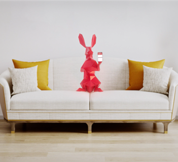 Hare using the Greater Anglia app on a sofa