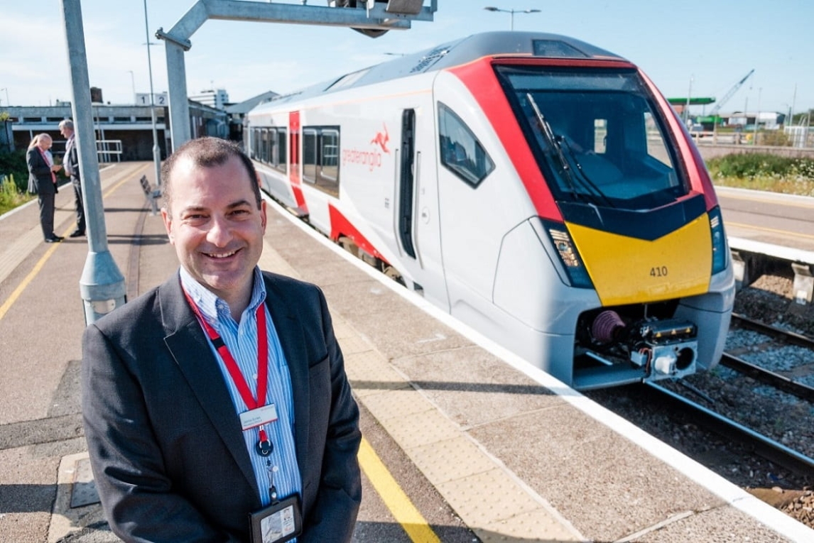 Jamie Burles standing next to Greater Anglia train 