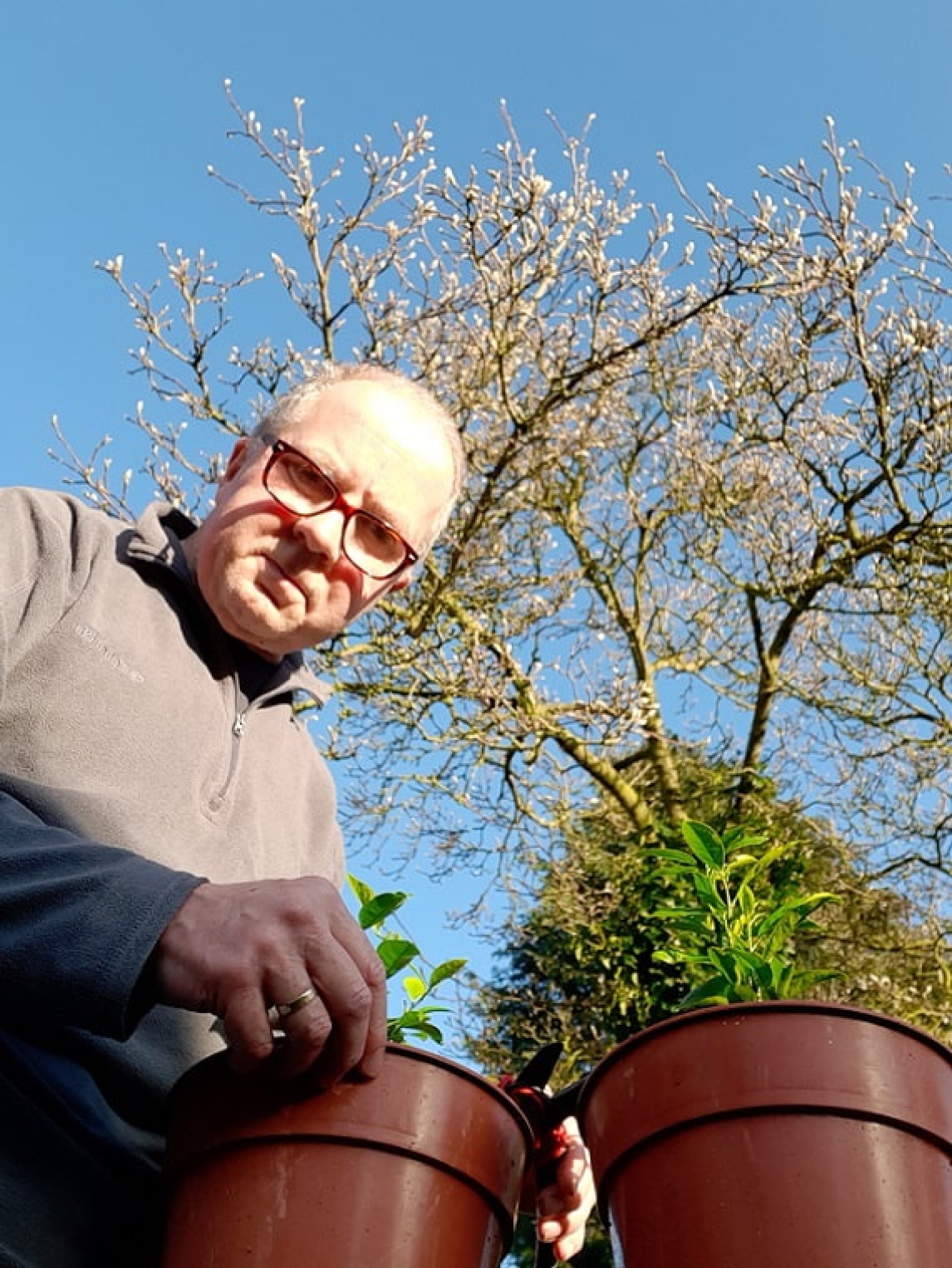 John Harwood holding a plant 