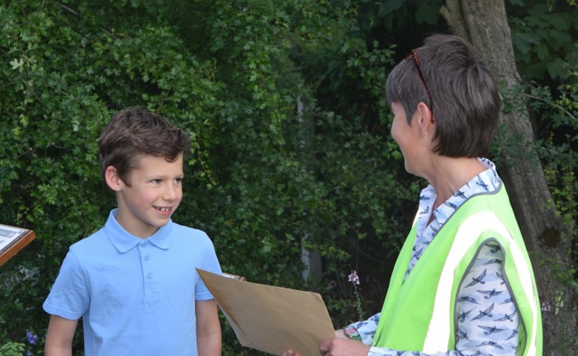 Sandy Burn, Westerfield station adopter, presents Elliot Clarke with his prize