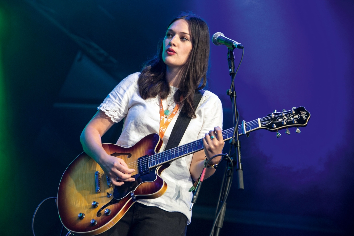 A woman playing the guitar